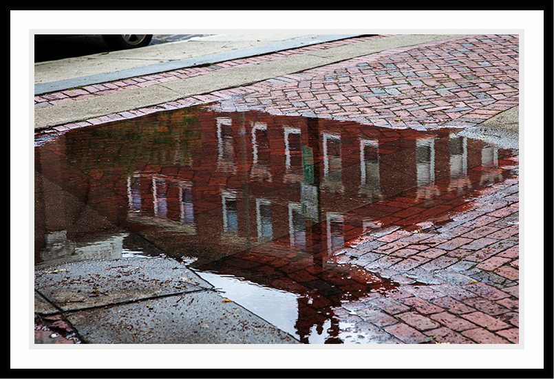 Reflection of a Boston public building in a pool of water.